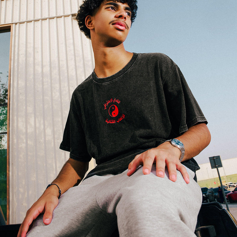 Arabic fighting game club tee in washed black, worn front view