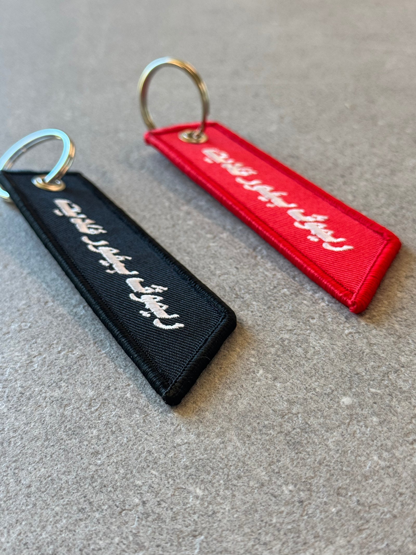 Remove Before Flight keychain clipped to a bag