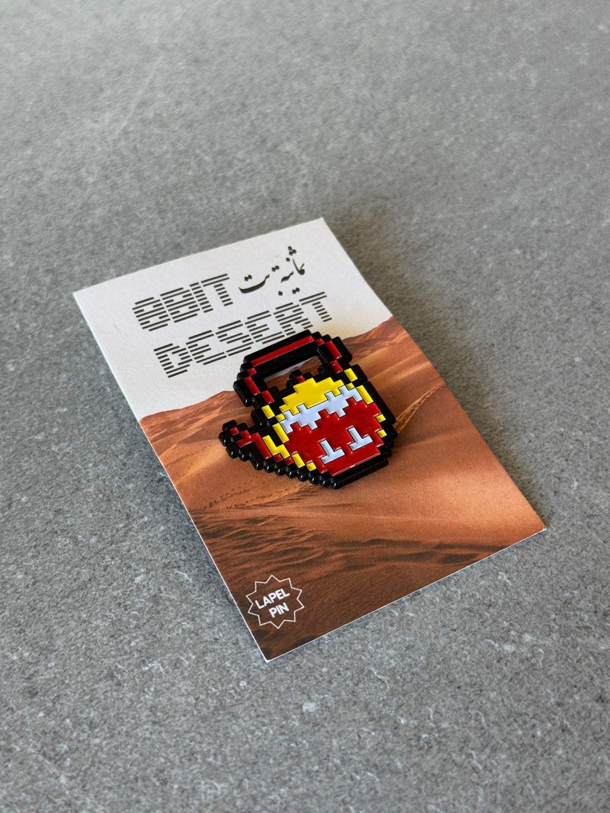 8-bit teapot enamel pin, close-up
