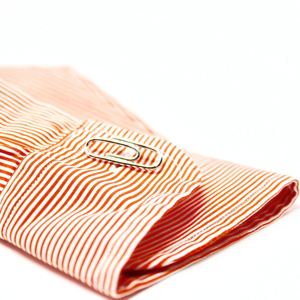 Paper clip cufflinks on a shirt cuff