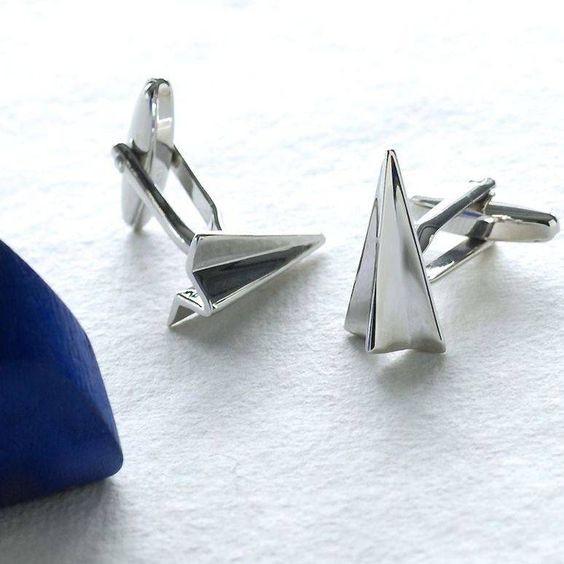 Paper aeroplane cufflinks, close-up