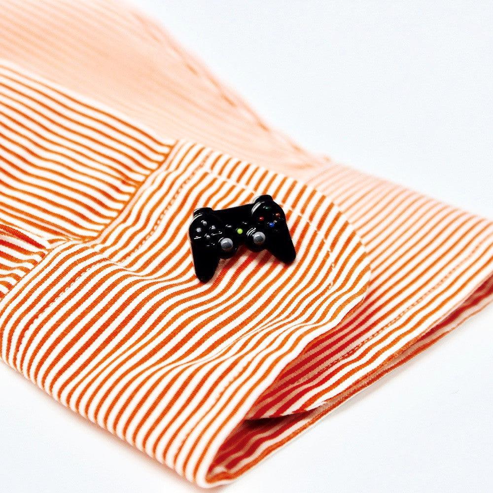Game controller cufflinks on a shirt cuff