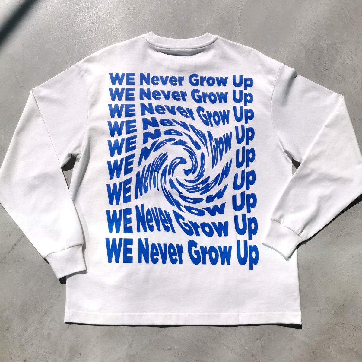 We Never Grow Up long sleeve tee by Elbotik, front view