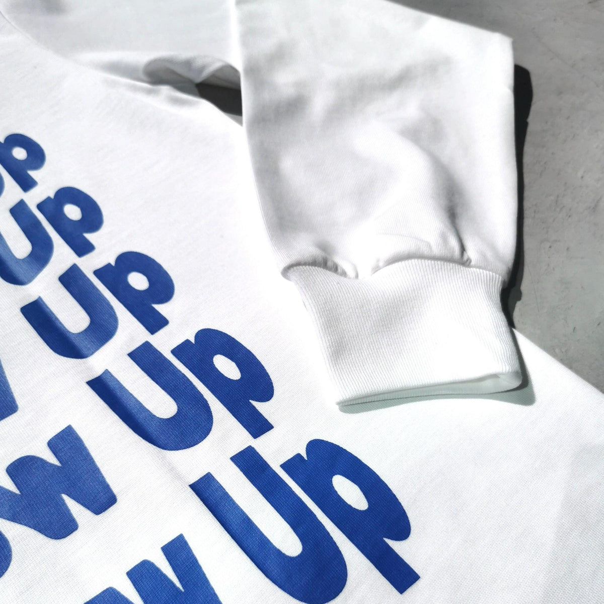 We Never Grow Up long sleeve, woven hem tag