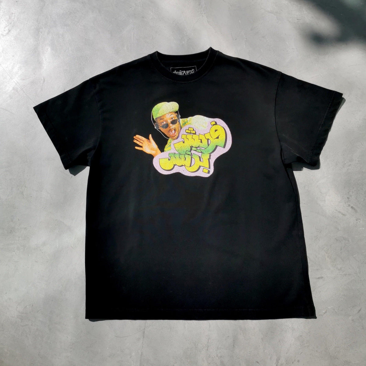 Retro washed 90s sitcom tee by Elbotik, front view