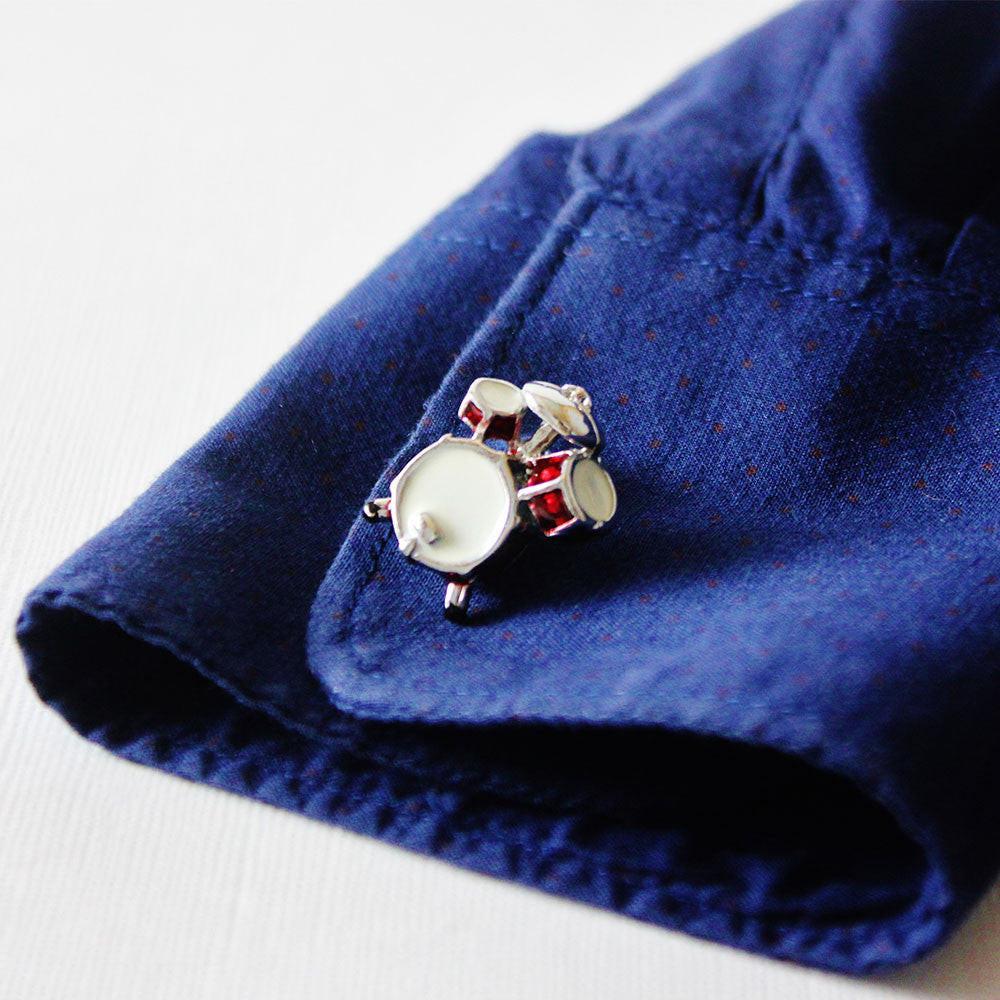 Drum kit cufflinks on a shirt cuff
