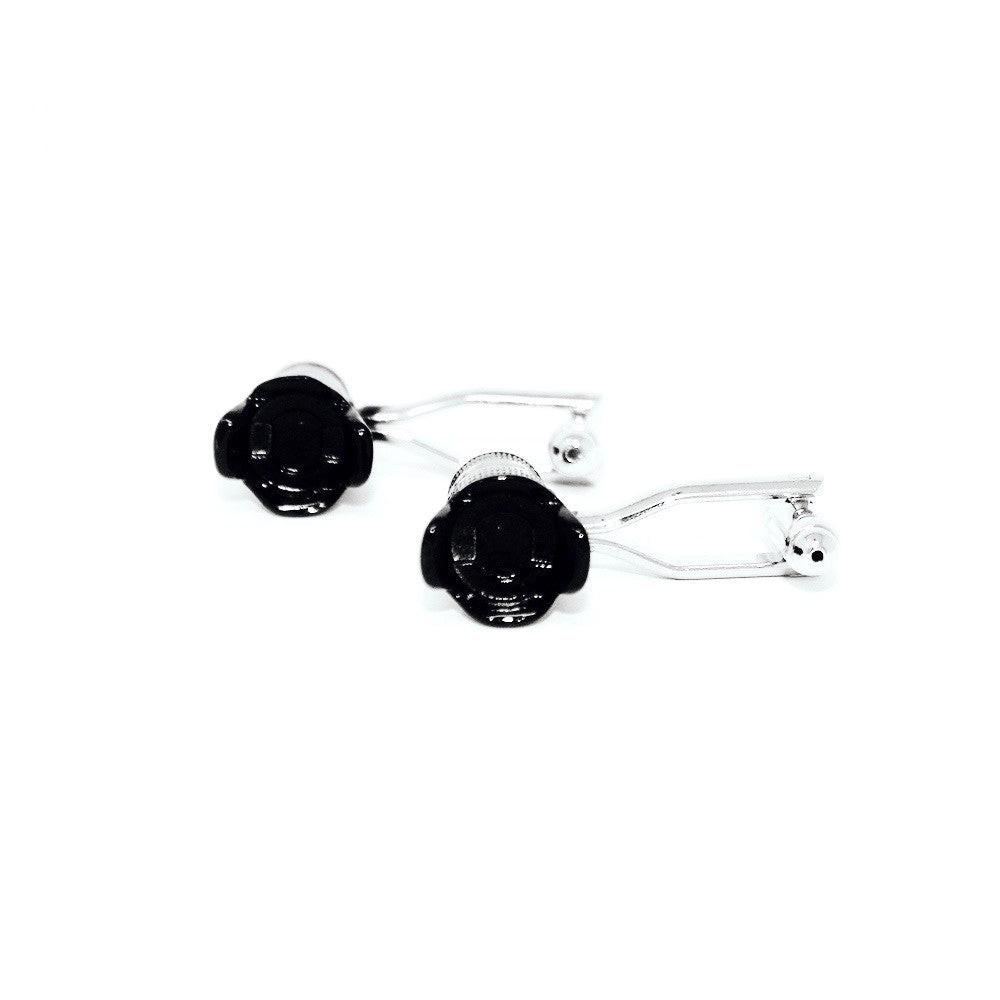 Camera lens cufflinks on a shirt cuff